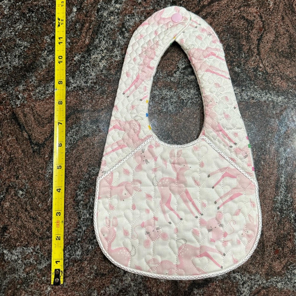 Handmade reversible quilted baby bib in pink deer print